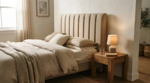 Channel-tufted upholstered bed headboard in a warm neutral bedroom