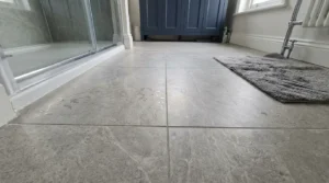 Large porcelain tiles on a UK bathroom floor in natural light.