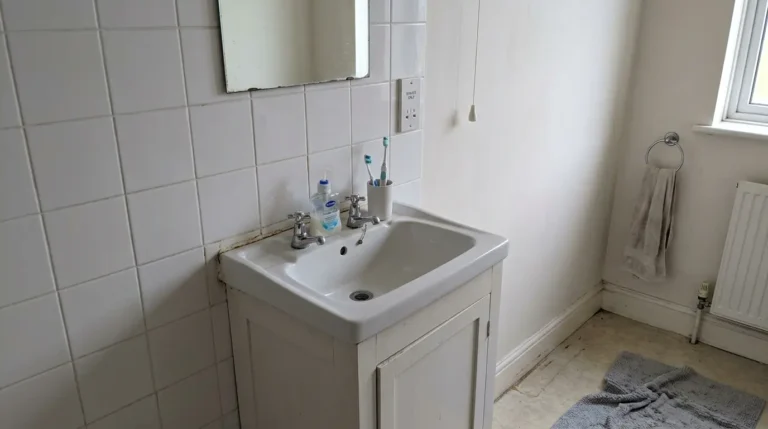 Bathroom vanity unit at standard height with a basin and mirror.