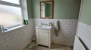 Bathroom vanity unit with basin and mirror in a UK bathroom.