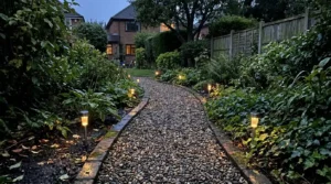 Garden path with solar lights at dusk in a UK garden.