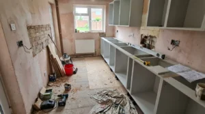 UK kitchen during renovation with new carcasses and quartz sample.