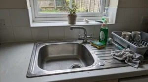 Kitchen sink with a single bowl and mixer tap in a UK kitchen.