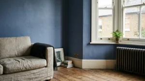 Soft indigo blue painted wall in a British living room with natural light.