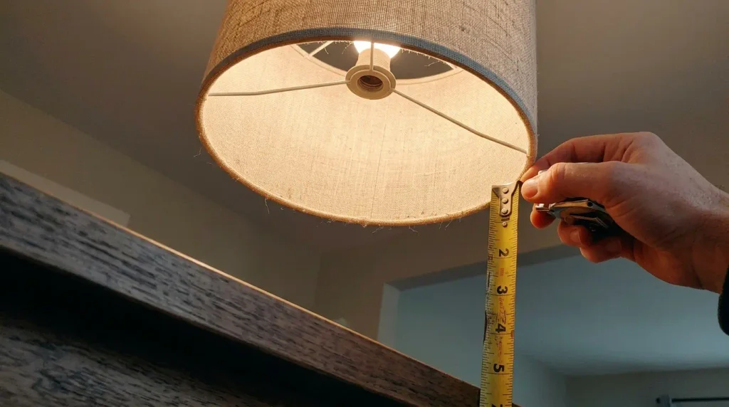 Pendant shade hanging above a dining table with the height gap visible.
