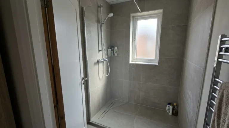 Large-format matt porcelain tiles in a UK bathroom shower.